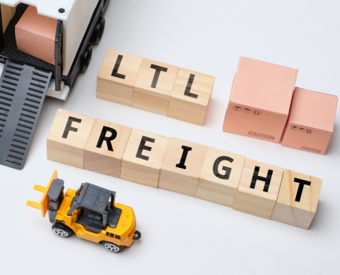 Small cubes with LTL FREIGHT written on them are sitting against a white background