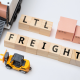 Small cubes with LTL FREIGHT written on them are sitting against a white background