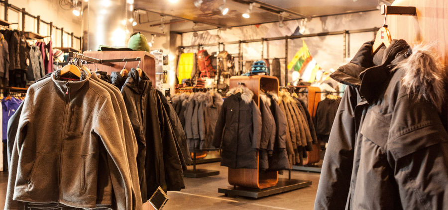 Coats hanging up at a dimly lit retail store