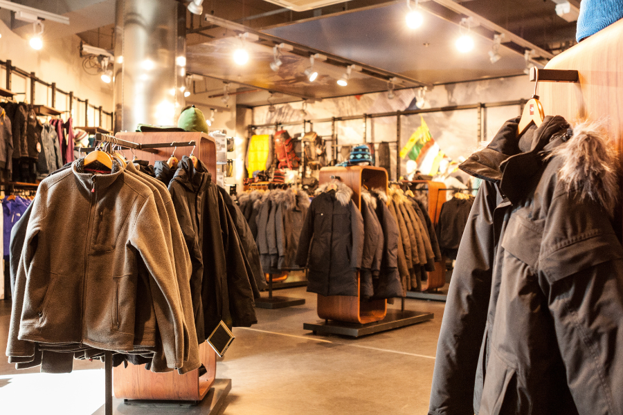 Coats hanging up at a dimly lit retail store