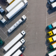 Semi trucks lined up on either side of a parking lot.